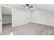 A bedroom with a ceiling fan, a closet and flooring at 7816 Wallace Ln, Charlotte, NC 28212