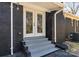 Inviting brick home entrance featuring a stylish black and gray exterior with double doors at 7816 Wallace Ln, Charlotte, NC 28212