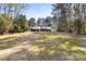 House with backyard surrounded by tall trees at 7816 Wallace Ln, Charlotte, NC 28212