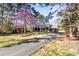 Exterior of home with pretty trees and a driveway at 7816 Wallace Ln, Charlotte, NC 28212