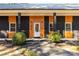 Close up of the front entrance showing black brick, wood trim, fresh landscaping and updated lighting at 7816 Wallace Ln, Charlotte, NC 28212