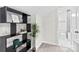 Hallway with shelves, a green plant, and an adjacent bathroom with modern finishes at 7816 Wallace Ln, Charlotte, NC 28212
