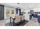 Open-concept kitchen and dining area featuring blue and white cabinets and ample natural light at 7816 Wallace Ln, Charlotte, NC 28212
