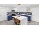 Modern kitchen features white cabinets, navy blue lower cabinets, a large island, and stainless steel appliances at 7816 Wallace Ln, Charlotte, NC 28212