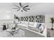 Comfortable living room featuring a sectional sofa, coffee table, shelving, and a ceiling fan at 7816 Wallace Ln, Charlotte, NC 28212