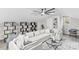 Stylish living room featuring a sectional sofa, coffee table, shelving, and a ceiling fan at 7816 Wallace Ln, Charlotte, NC 28212