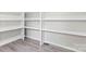 Spacious walk-in pantry with ample shelving for storage at 7816 Wallace Ln, Charlotte, NC 28212