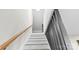 Bright staircase with white risers, wooden handrail, and dark decorative wood panels at 7816 Wallace Ln, Charlotte, NC 28212