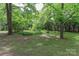 Spacious backyard with mature trees providing shade and privacy, ideal for enjoying nature and outdoor gatherings at 783 Carpenter Ave, Mooresville, NC 28115
