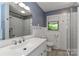 Stylish bathroom featuring modern fixtures, blue accent walls, and a glass-enclosed shower at 783 Carpenter Ave, Mooresville, NC 28115