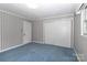 Bedroom featuring wallpapered walls, blue carpet, and closet space offering a cozy retreat at 783 Carpenter Ave, Mooresville, NC 28115
