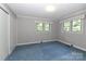 Bedroom with wallpaper, blue carpet, and two windows offering natural light at 783 Carpenter Ave, Mooresville, NC 28115