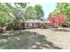 Charming brick home with mature trees and landscaping, creating a welcoming curb appeal at 783 Carpenter Ave, Mooresville, NC 28115