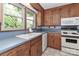 Classic kitchen with wood cabinets, white appliances, and blue countertops at 783 Carpenter Ave, Mooresville, NC 28115