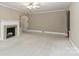 Bright living room with a fireplace, ceiling fan, carpeted floors, and neutral paint at 783 Carpenter Ave, Mooresville, NC 28115