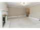 Bright living room with a fireplace, ceiling fan, carpeted floors, and neutral paint at 783 Carpenter Ave, Mooresville, NC 28115