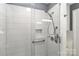 Modern shower featuring white tile, a glass door, and a convenient built-in niche at 783 Carpenter Ave, Mooresville, NC 28115