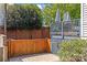 Private outdoor patio space with wood fence and upper level deck area with umbrellas, great for entertaining at 806 Sunnyside Ave, Charlotte, NC 28204