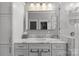 Bright bathroom vanity featuring marble countertop, drawers and cabinets, and a large, well-lit mirror at 806 Sunnyside Ave, Charlotte, NC 28204