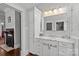 Bathroom vanity featuring marble countertop, drawers and cabinets, with hallway view and natural light at 806 Sunnyside Ave, Charlotte, NC 28204