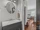 Bright bathroom with white marble sink and natural light, featuring hardwood floors at 806 Sunnyside Ave, Charlotte, NC 28204