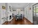 Dining room with a white fireplace, hardwood floors, and plenty of natural light from the windows at 806 Sunnyside Ave, Charlotte, NC 28204