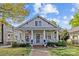 Charming home featuring a lovely front porch, manicured landscaping, and classic architectural details at 806 Sunnyside Ave, Charlotte, NC 28204