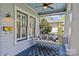 Relaxing porch with a swing, modern light fixture, and a blue rug at 806 Sunnyside Ave, Charlotte, NC 28204