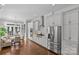 Modern kitchen featuring hardwood floors, stainless steel appliances, and a bright breakfast nook at 806 Sunnyside Ave, Charlotte, NC 28204