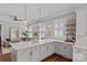 Bright kitchen island with quartz countertops, pendant lighting, and seating area with cozy living room at 806 Sunnyside Ave, Charlotte, NC 28204