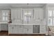 Farmhouse kitchen featuring an island with quartz counters, hardwood floors, and stainless steel dishwasher at 806 Sunnyside Ave, Charlotte, NC 28204