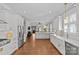 Spacious kitchen featuring white cabinets, a large island, and stainless steel appliances at 806 Sunnyside Ave, Charlotte, NC 28204