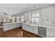 Bright, open kitchen featuring white cabinetry, a farmhouse sink, and stainless steel appliances at 806 Sunnyside Ave, Charlotte, NC 28204
