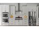 Elegant kitchen with stainless steel appliances, including double ovens and a gas range at 806 Sunnyside Ave, Charlotte, NC 28204