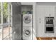 Convenient laundry closet with stacked washer/dryer and built in oven and microwave combo at 806 Sunnyside Ave, Charlotte, NC 28204