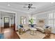 Open-concept living room with hardwood floors, statement mirror, and large, curved sofa at 806 Sunnyside Ave, Charlotte, NC 28204