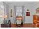 Well-lit office with a desk, wooden accents, and a comfortable chair on a red patterned rug at 806 Sunnyside Ave, Charlotte, NC 28204