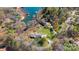 Aerial view of a luxurious waterfront property with private docks, a lush landscape, and multiple homes at 8194 Mallard Rd, Denver, NC 28037