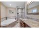 Luxurious bathroom with a soaking tub, glass-enclosed shower, granite countertops, and tiled floors at 8194 Mallard Rd, Denver, NC 28037
