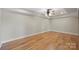 Spacious bedroom with hardwood floors, recessed lighting, and a tray ceiling with a fan at 8194 Mallard Rd, Denver, NC 28037