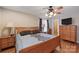 Tranquil bedroom with wood furnishings, hardwood floors, a ceiling fan, and natural light from the windows at 8194 Mallard Rd, Denver, NC 28037