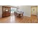Charming dining area with a wood table set, hardwood floors, and natural light from a large window at 8194 Mallard Rd, Denver, NC 28037