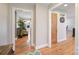 Inviting hallway featuring hardwood floors, neutral walls, and an open view into the living area at 8194 Mallard Rd, Denver, NC 28037