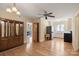 View of kitchen with white cabinets, stainless steel fridge, wood floors, and an adjacent room at 8194 Mallard Rd, Denver, NC 28037