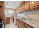 Functional laundry room with granite counters, built-in cabinets, sink, and a washer and dryer at 8194 Mallard Rd, Denver, NC 28037
