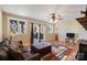 Comfortable living room with sliding glass doors, hardwood floors, and a decorative stained-glass window at 8194 Mallard Rd, Denver, NC 28037