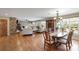 Open concept living space with stone fireplace, dining area, hardwood floors, and plenty of natural light at 8194 Mallard Rd, Denver, NC 28037