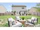 Spacious backyard with a lush lawn, outdoor seating, and a charming pergola at 9230 Avery Meadows Dr, Charlotte, NC 28216