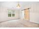 Inviting bedroom with a unique sliding barn door, natural light, and cozy carpeting, perfect for comfort at 9230 Avery Meadows Dr, Charlotte, NC 28216