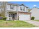 Charming two-story home features a gray siding, stone accents, and a two-car garage at 9230 Avery Meadows Dr, Charlotte, NC 28216